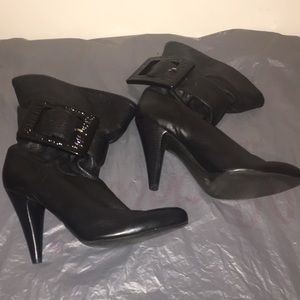 Black ankle heel boot with a buckle.